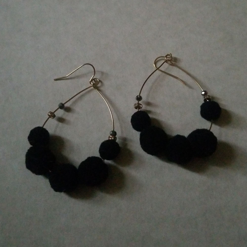 Gold drop earrings with fun black poms